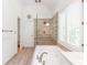Bright bathroom with a tiled shower, soaking tub, white shutters, and modern fixtures at 3902 Concord Walk Se Dr, Smyrna, GA 30082