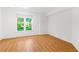Bedroom featuring laminate flooring and a large window overlooking a green lawn at 3902 Concord Walk Se Dr, Smyrna, GA 30082
