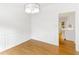 Dining room with hardwood floors, paneled wainscoting, and a modern chandelier, adjacent to the kitchen at 3902 Concord Walk Se Dr, Smyrna, GA 30082