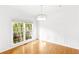 Sunlit dining room with hardwood floors, decorative wall trim, modern lighting, and large window views at 3902 Concord Walk Se Dr, Smyrna, GA 30082