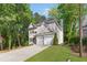 Charming two-story home with a well-manicured lawn, attached garage, and mature trees at 3902 Concord Walk Se Dr, Smyrna, GA 30082