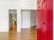 Bright foyer featuring hardwood floors, a striking red door, and views into the kitchen and stairway at 3902 Concord Walk Se Dr, Smyrna, GA 30082