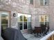 Inviting back porch with brick exterior, outdoor seating and adjacent entrance door at 12640 Hearthstone Way, Alpharetta, GA 30009