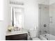 Clean bathroom design with shower and tub combination with glass door and dark wood vanity at 12640 Hearthstone Way, Alpharetta, GA 30009