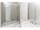 Bright bathroom with glass shower wall, white cabinets, and modern fixtures at 12640 Hearthstone Way, Alpharetta, GA 30009