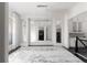 Elegant dining room with white trim, large mirrors and a chandelier adding to the appeal at 12640 Hearthstone Way, Alpharetta, GA 30009