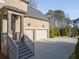 Brick home with a three car garage and well maintained lawn and landscaping at 12640 Hearthstone Way, Alpharetta, GA 30009