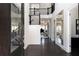 Elegant foyer with dark wood floors and a view of the staircase, accented by natural light at 12640 Hearthstone Way, Alpharetta, GA 30009