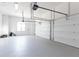 Spacious garage with epoxy floors, windows, and overhead door with opener at 12640 Hearthstone Way, Alpharetta, GA 30009