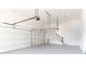 Large two car garage featuring an epoxy floor and plenty of overhead lighting at 12640 Hearthstone Way, Alpharetta, GA 30009