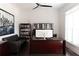 Bright home office with dark wood desk, leather sofa, and natural light is ideal for remote work at 12640 Hearthstone Way, Alpharetta, GA 30009