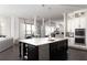 Open-concept kitchen with a large island, modern appliances, and seamless flow to the dining area at 12640 Hearthstone Way, Alpharetta, GA 30009