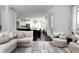 Open-concept living room with a large sectional, dining area and modern decor providing a relaxed atmosphere at 12640 Hearthstone Way, Alpharetta, GA 30009
