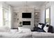 Cozy living room featuring a modern fireplace, built-in shelving, and bright windows at 12640 Hearthstone Way, Alpharetta, GA 30009