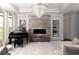 Elegant living room with a grand piano, fireplace, and stunning chandelier at 12640 Hearthstone Way, Alpharetta, GA 30009