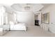 Luxurious main bedroom featuring modern chandelier, accent wall art, and upholstered headboard at 12640 Hearthstone Way, Alpharetta, GA 30009