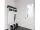 Bright mudroom features a storage bench with baskets and hooks, adjacent to an exterior door at 12640 Hearthstone Way, Alpharetta, GA 30009
