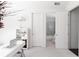 Bright home office with white desk, shelving, and adjacent bathroom provides functional, adaptable space at 12640 Hearthstone Way, Alpharetta, GA 30009