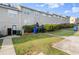 View of the back exterior of the townhome, showing the lawn and parking spot at 241 Odyssey Turn Nw, Conyers, GA 30012