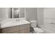 Bright bathroom features a modern vanity, a toilet, and a tub with white tile at 241 Odyssey Turn Nw, Conyers, GA 30012