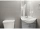 This bathroom features a gray vanity with sink and a white toilet at 241 Odyssey Turn Nw, Conyers, GA 30012
