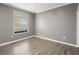 This bedroom has hardwood flooring and a window at 241 Odyssey Turn Nw, Conyers, GA 30012