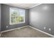 This bedroom has a large window that provides plenty of natural light at 241 Odyssey Turn Nw, Conyers, GA 30012
