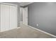 This bedroom has plush carpeting, a neutral wall color, and a double door closet for easy storage at 241 Odyssey Turn Nw, Conyers, GA 30012