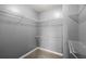 Walk-in closet with white wire shelving provides efficient storage space at 241 Odyssey Turn Nw, Conyers, GA 30012