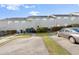 The back exterior of the townhome and the parking area at 241 Odyssey Turn Nw, Conyers, GA 30012