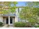 Inviting exterior of a townhouse featuring a well-maintained lawn and neutral color scheme at 241 Odyssey Turn Nw, Conyers, GA 30012