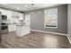 Spacious kitchen features white cabinets, stainless appliances, gray walls, and hardwood floors, creating a modern aesthetic at 241 Odyssey Turn Nw, Conyers, GA 30012