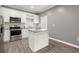 A kitchen boasts white cabinets, stainless steel appliances, and an island with a light gray countertop at 241 Odyssey Turn Nw, Conyers, GA 30012