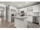 Well-equipped kitchen with stainless steel appliances, island, and bright lighting at 241 Odyssey Turn Nw, Conyers, GA 30012
