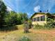 Exterior shot of home featuring an overgrown yard at 5700 Abbotts Bridge Rd, Johns Creek, GA 30097