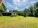 Exterior home view with sprawling lawn, blue skies, and lush surroundings at 5700 Abbotts Bridge Rd, Johns Creek, GA 30097