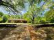 Residential home featuring a driveway and partial view of the property's spacious, green landscape at 5700 Abbotts Bridge Rd, Johns Creek, GA 30097