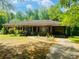Charming single-story home with a lush front yard, driveway, and inviting curb appeal at 5700 Abbotts Bridge Rd, Johns Creek, GA 30097