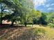 Picturesque property view of the lush surroundings under a sunny sky at 5700 Abbotts Bridge Rd, Johns Creek, GA 30097