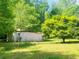 Spacious yard with an outbuilding and mature tree offering shade at 5700 Abbotts Bridge Rd, Johns Creek, GA 30097