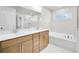 Stylish bathroom with double sinks, a large mirror, and a separate bathtub at 5761 Tillman Way, Powder Springs, GA 30127