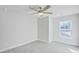 Neutral bedroom with a ceiling fan, light carpet and bright window at 5761 Tillman Way, Powder Springs, GA 30127