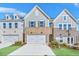 Charming townhomes featuring brick accents, siding, two-car garages and well-manicured landscaping at 5761 Tillman Way, Powder Springs, GA 30127