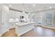 Modern kitchen features white cabinets, stainless appliances, kitchen island and outdoor access at 5761 Tillman Way, Powder Springs, GA 30127
