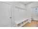 Functional mud room features storage bench and coat hooks next to a restroom at 5761 Tillman Way, Powder Springs, GA 30127
