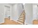 Staircase with wood treads and white risers between two doorways in the home at 5761 Tillman Way, Powder Springs, GA 30127