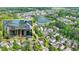 Aerial view of a well maintained home in a landscaped community near a lake at 7160 Round Rd, Cumming, GA 30040