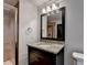 Bathroom featuring granite countertops, framed mirror, shower and vanity at 7160 Round Rd, Cumming, GA 30040