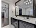 Stylish bathroom featuring dual vanities, modern lighting, and a large mirror at 7160 Round Rd, Cumming, GA 30040