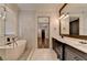 Bright bathroom showcasing a soaking tub, modern fixtures, and marble tile at 7160 Round Rd, Cumming, GA 30040